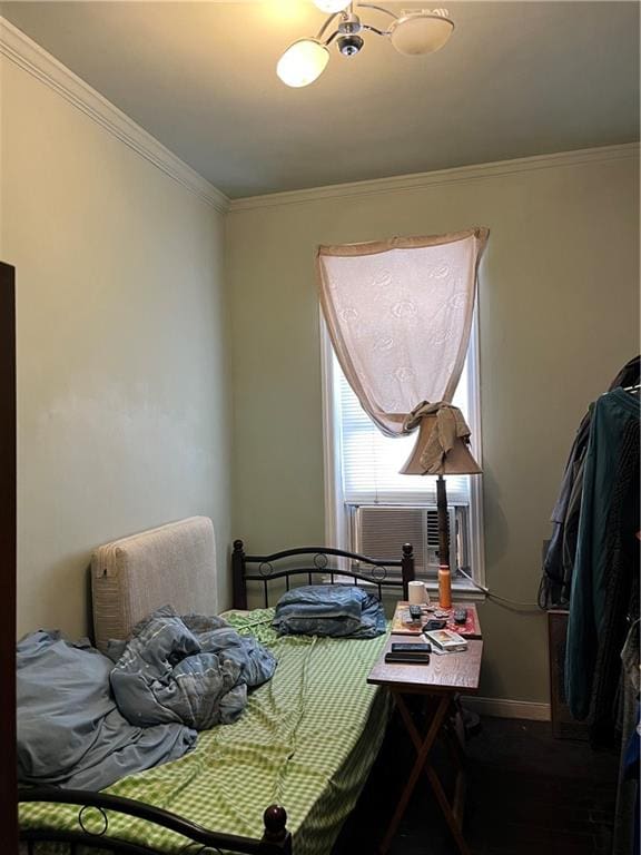 bedroom featuring cooling unit, baseboards, and ornamental molding