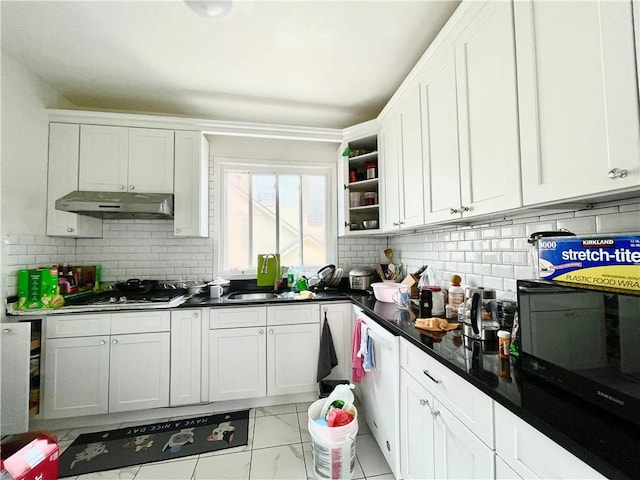 kitchen featuring under cabinet range hood, stainless steel gas cooktop, white cabinets, and black microwave