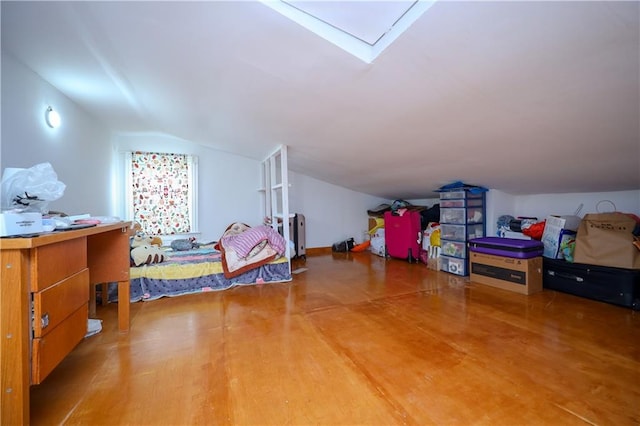 bedroom with hardwood / wood-style flooring and lofted ceiling