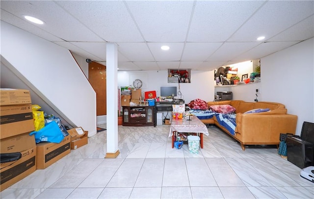 recreation room with a paneled ceiling