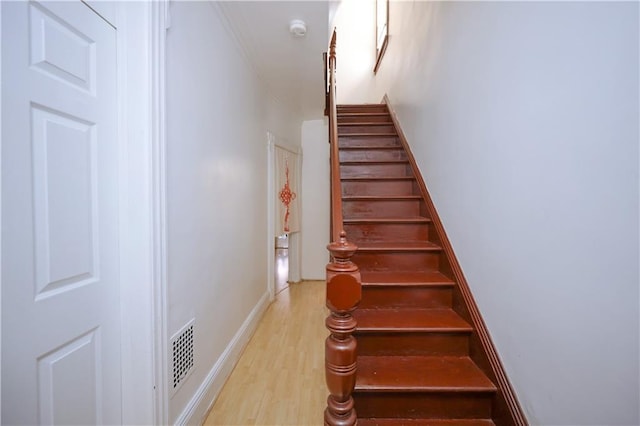 stairway featuring wood-type flooring