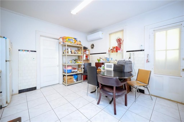 dining area with an AC wall unit, tile walls, light tile patterned floors, and ornamental molding