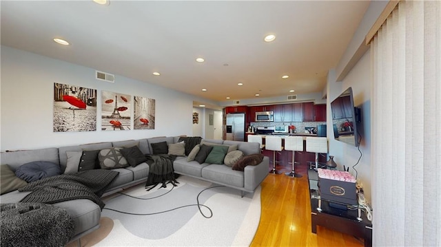 living room with light hardwood / wood-style floors