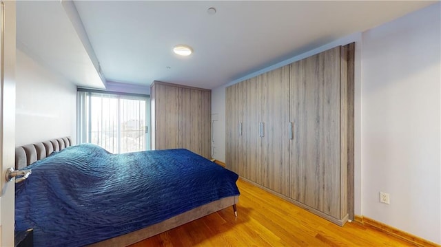 bedroom with light hardwood / wood-style flooring