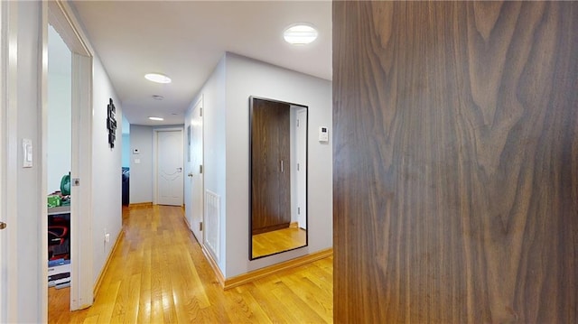 hallway with light hardwood / wood-style flooring