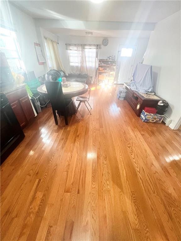 unfurnished dining area featuring light wood-type flooring