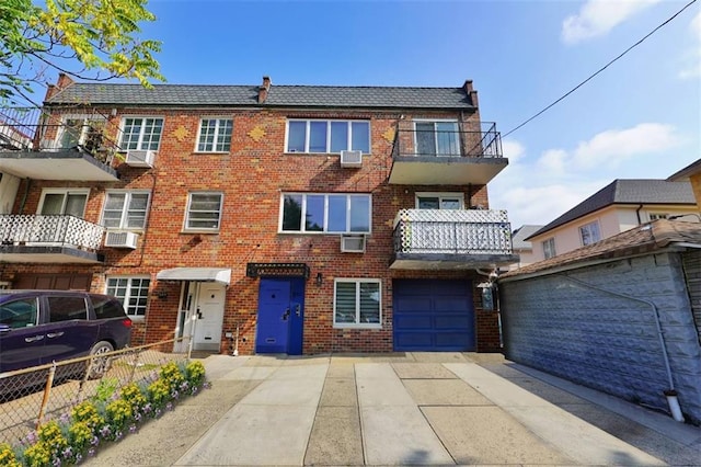 townhome / multi-family property featuring brick siding, driveway, and fence