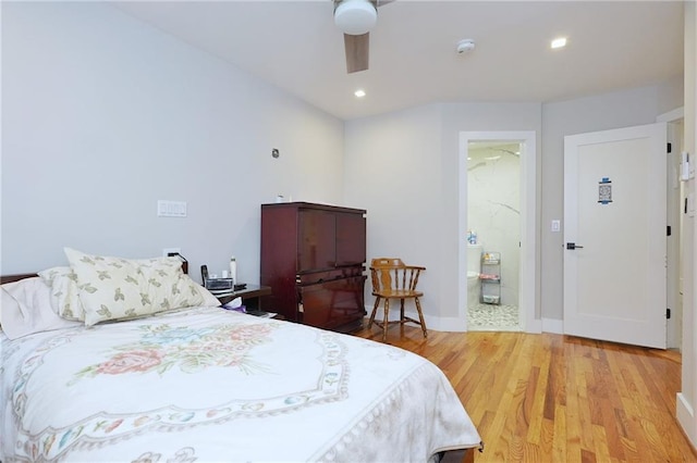 bedroom featuring light wood-type flooring, ensuite bathroom, and ceiling fan