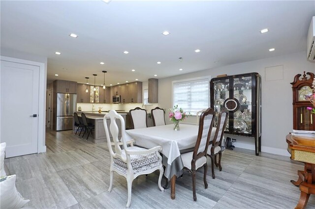 dining room with recessed lighting and an AC wall unit