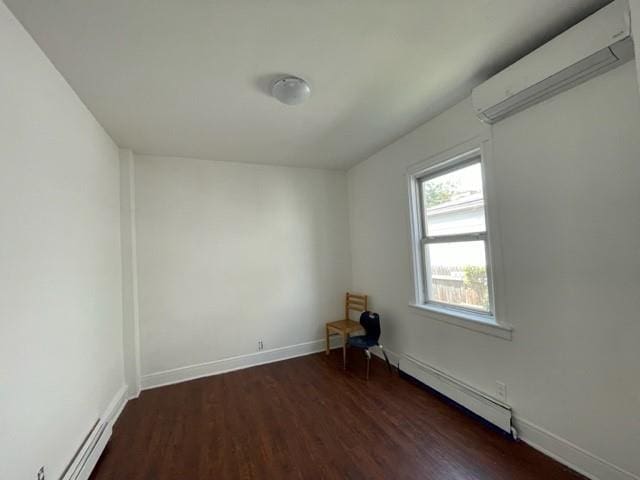 empty room featuring a baseboard radiator and dark hardwood / wood-style floors