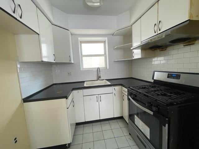 kitchen featuring white cabinetry, gas range, sink, and light tile patterned floors