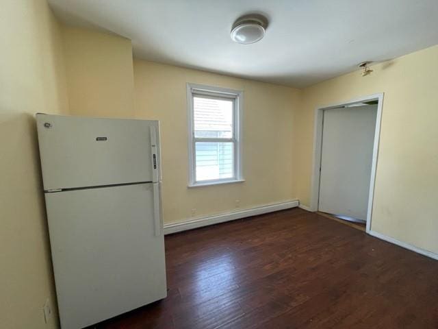 kitchen with a baseboard radiator, dark hardwood / wood-style floors, and white fridge