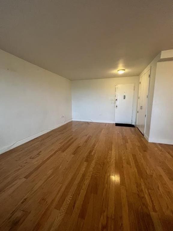 interior space featuring baseboards and wood finished floors