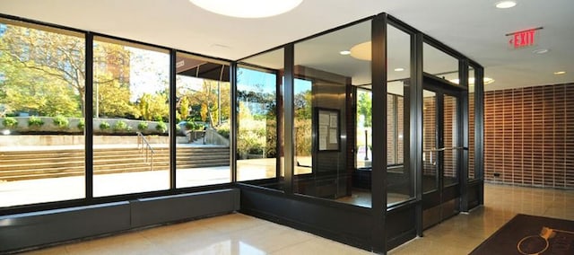 entryway featuring expansive windows and tile patterned flooring