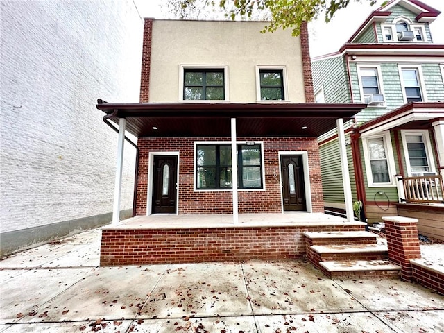 view of front of property with cooling unit and a porch