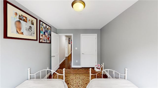 bedroom featuring baseboards and wood finished floors