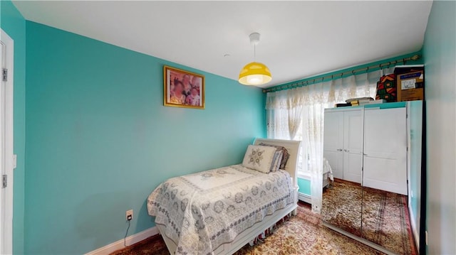 bedroom with a closet and baseboards