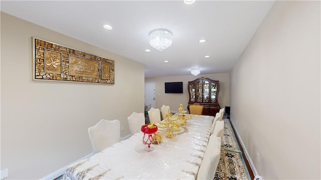 dining area with baseboards, a notable chandelier, and recessed lighting