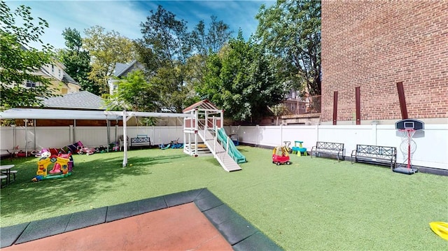 view of play area with a fenced backyard and a yard