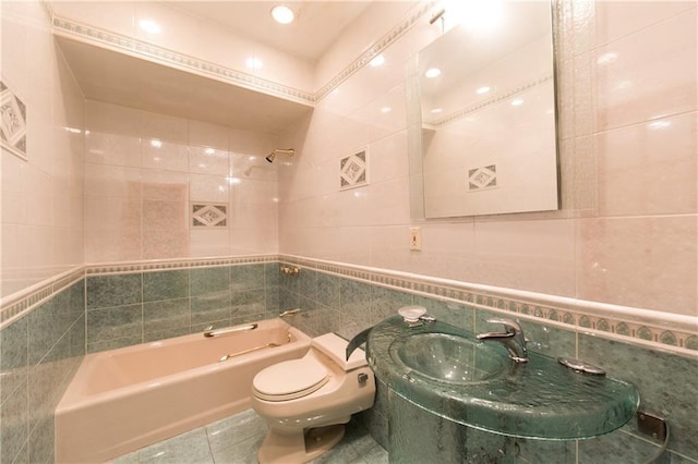 full bathroom with tile patterned flooring, shower / washtub combination, sink, tile walls, and toilet