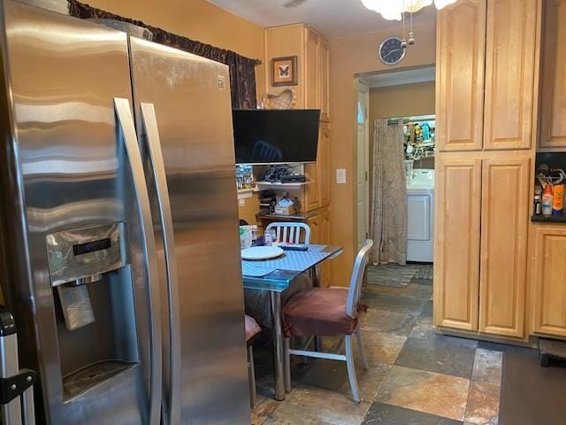 kitchen featuring washer / dryer, stainless steel fridge, and light brown cabinetry