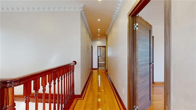 corridor with hardwood / wood-style floors and ornamental molding