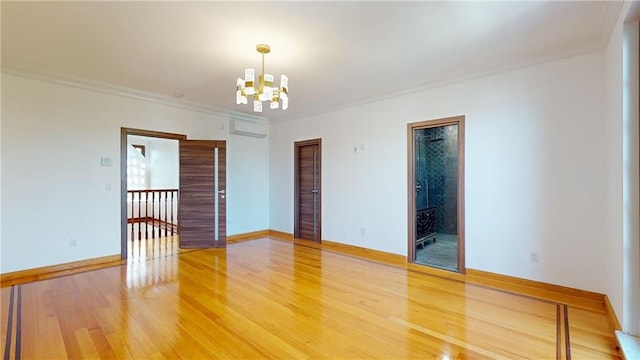 unfurnished room featuring a wall mounted AC, crown molding, hardwood / wood-style floors, and a chandelier