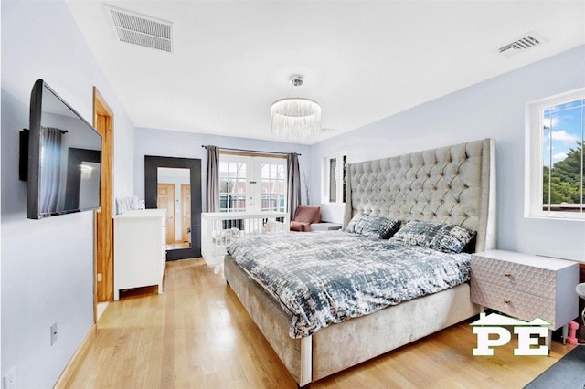 bedroom featuring light hardwood / wood-style flooring and multiple windows