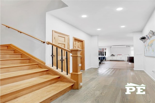 interior space featuring hardwood / wood-style floors and a wall unit AC