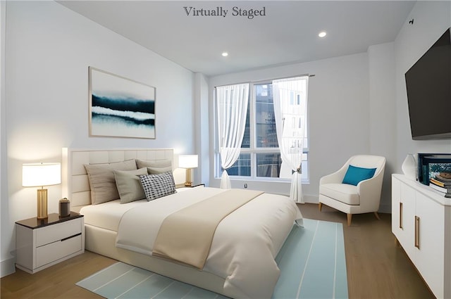 bedroom featuring light wood-type flooring and recessed lighting