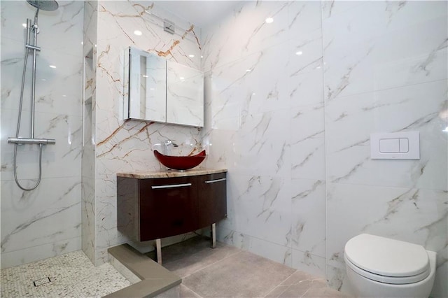 bathroom with toilet, vanity, and a marble finish shower