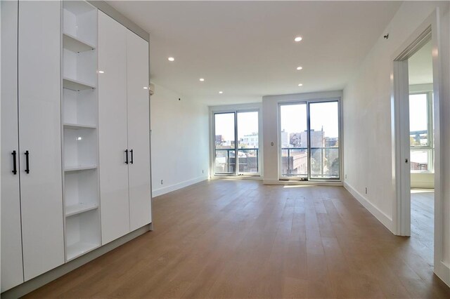 9964 3rd Ave Unit 5A, Brooklyn, NY 11209 - unfurnished living room with built in shelves, light wood finished floors, and recessed lighting