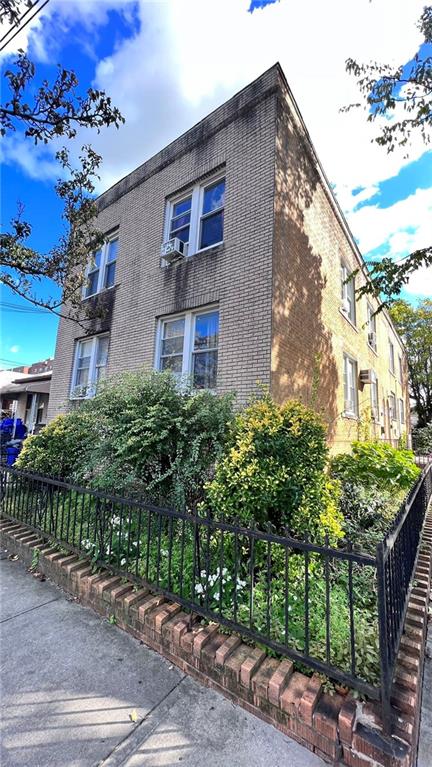 exterior space with brick siding and fence