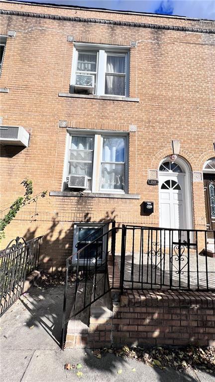 rear view of property with brick siding