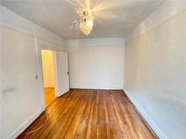 spare room with ceiling fan and hardwood / wood-style flooring