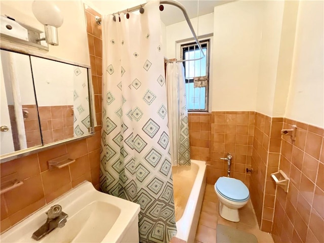 full bathroom with sink, tile walls, tile patterned flooring, shower / bath combo, and toilet