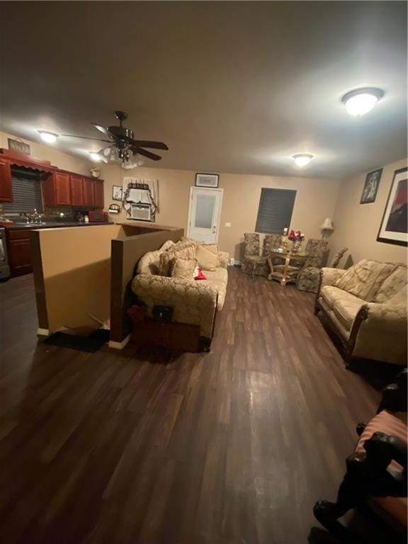 living room featuring ceiling fan and dark wood-type flooring