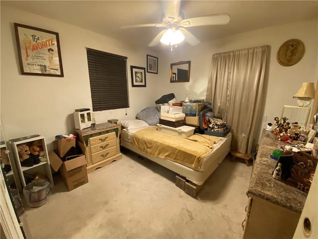 bedroom featuring a ceiling fan and light carpet