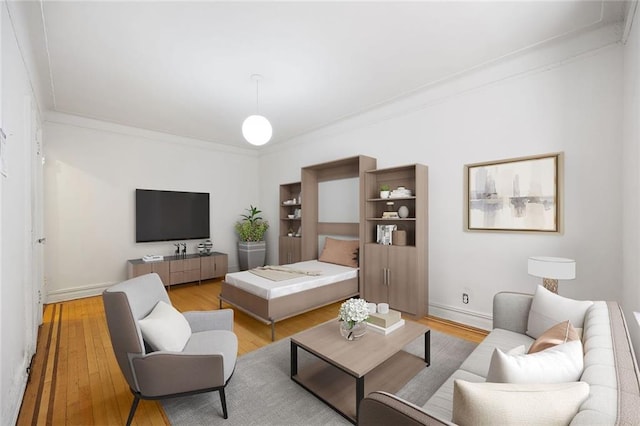 living room with baseboards, light wood-type flooring, and ornamental molding