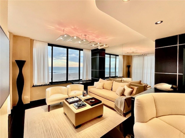 living room with rail lighting and a water view