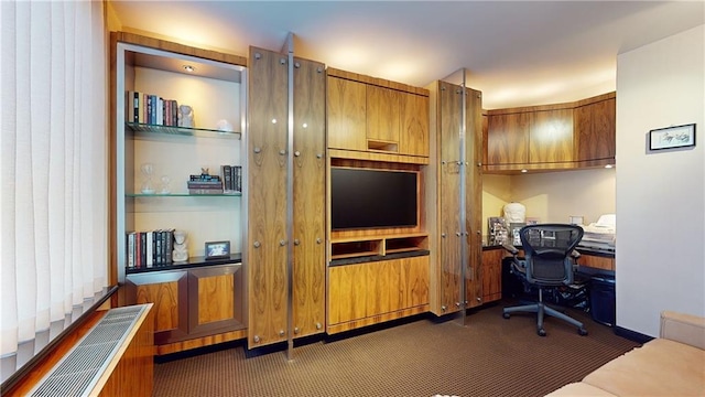 office featuring built in desk and dark carpet