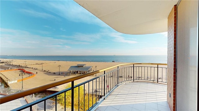 balcony featuring a water view and a beach view