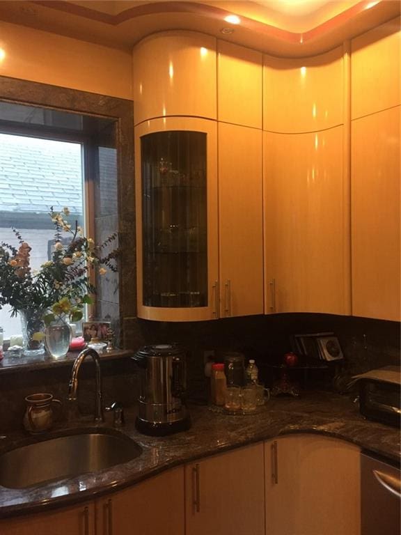 kitchen with dark stone counters and sink