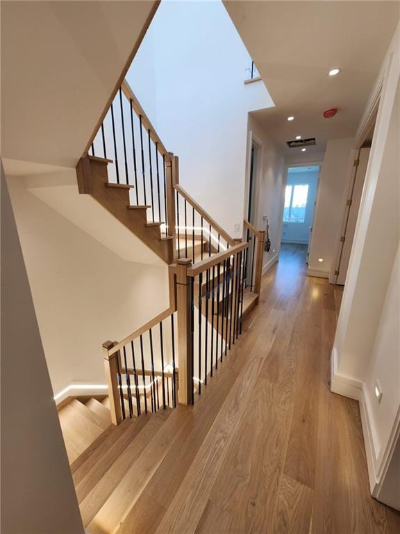 stairway with wood-type flooring