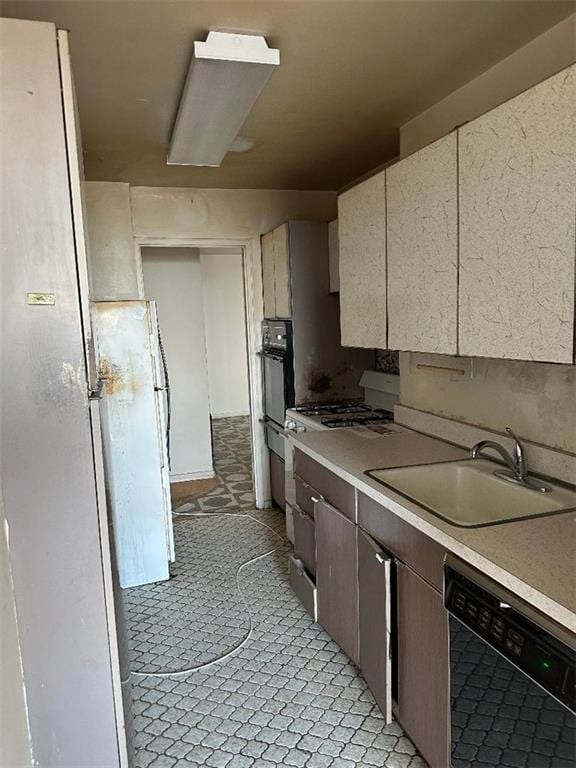 kitchen featuring black appliances, sink, and light tile patterned floors