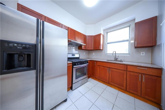 kitchen featuring appliances with stainless steel finishes, sink, light tile patterned floors, and light stone countertops