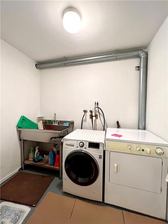 laundry area featuring separate washer and dryer, washer hookup, and tile floors