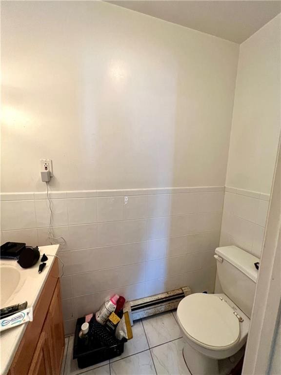 bathroom featuring tile walls, tile flooring, vanity, and toilet