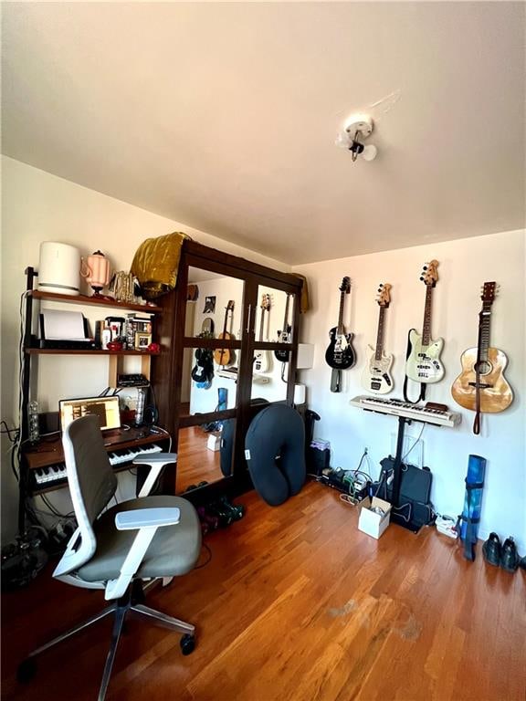 home office with hardwood / wood-style flooring