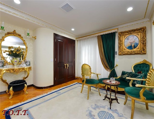 sitting room featuring parquet flooring and crown molding